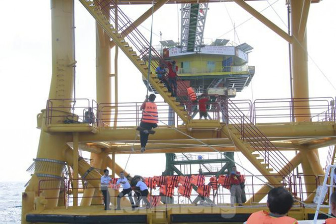 Sau rất nhiều lần thử các phương án đưa các đại biểu phóng viên, nhà báo lên các nhà giàn DK1 không thành công, mãi gần đến ngày cuối cùng, đoàn công tác mới lên được nhà giàn DK1/16 bằng phương án thang dây. Ảnh: Trường Phong