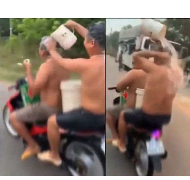 Video hai người đàn ông Việt tắm gội trên xe máy lên báo ngoại - 1