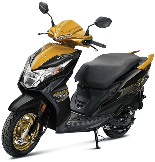 Phiên bản tiêu chuẩn của 2020 Honda Dio trang bị vành bánh màu đen, còn bản Deluxe có vành màu vàng nhìn khá chất. Ảnh 2020 Honda Dio bản Deluxe màu vàng đen.
