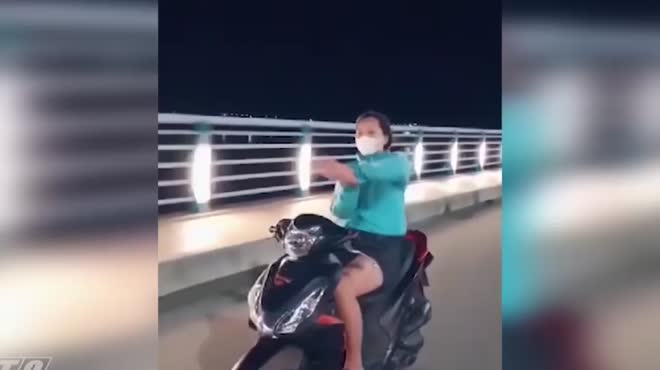 Cô gái chạy xe máy thả 2 tay... múa quạt bị phạt 7,4 triệu đồng