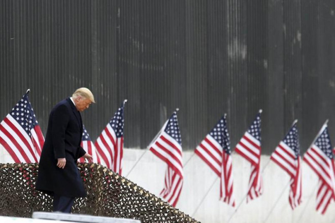 Tổng thống Donald Trump bước xuống bục phát biểu khi ông đi thăm bức tường biên giới Mỹ - Mexico ở bang Texas ngày 12-1. Ảnh: AP