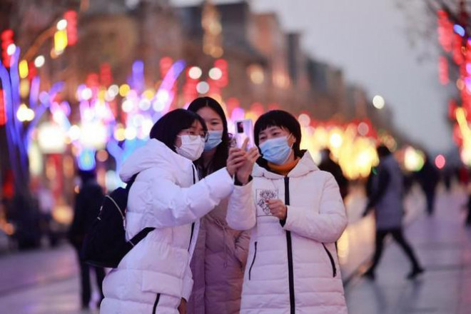 Các cô gái chụp ảnh tự sướng trên
đường phố Bắc Kinh.