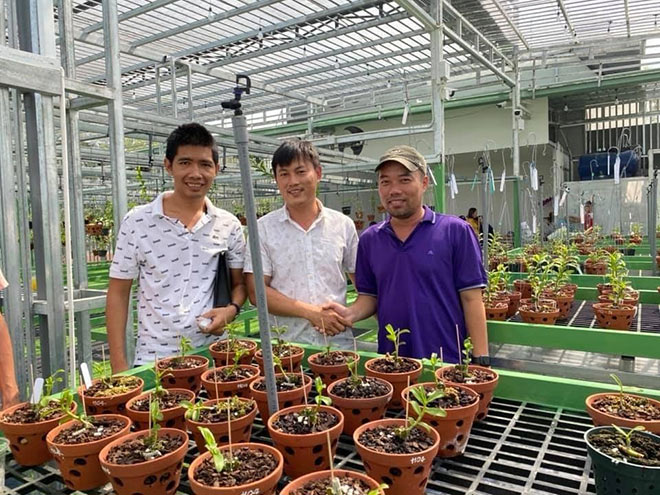 Lê Cao Thắng (bên trái) cùng khách hàng của mình.