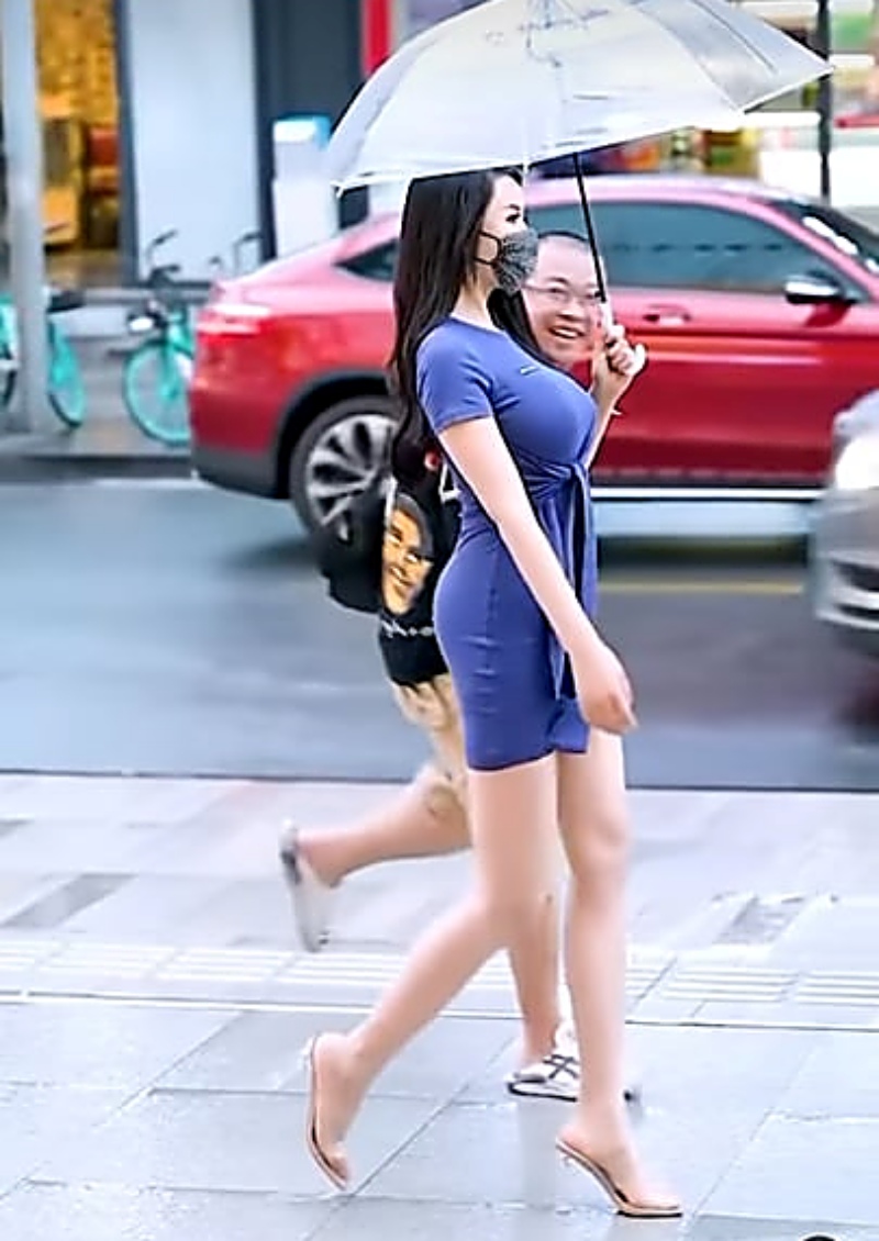 Cô gái Trung Quốc diện váy bodycon sải bước trên đường phố.