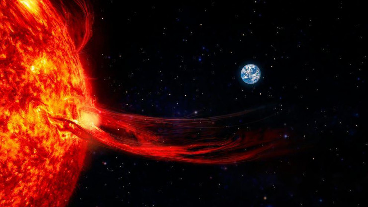 Ảnh đồ họa cho thấy Trái Đất nhỏ bé và những quả pháo sáng bùng nổ từ Mặt Trời - Ảnh: LIVE SCIENCE