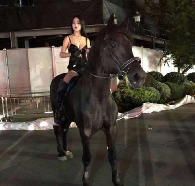 Một cô gái gây chú ý vì mặc đồ ngắn, cưỡi ngựa trên đường phố Thượng Hải.