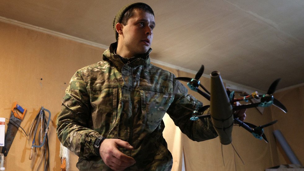 Binh sĩ Ukraine cầm một UAV có gắn đầu đạn (ảnh: RT)