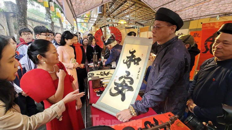 Phu nhân Tổng thống Philippines được thầy đồ tặng chữ trong buổi đi thăm phố cổ và chợ hoa Tết Hà Nội.