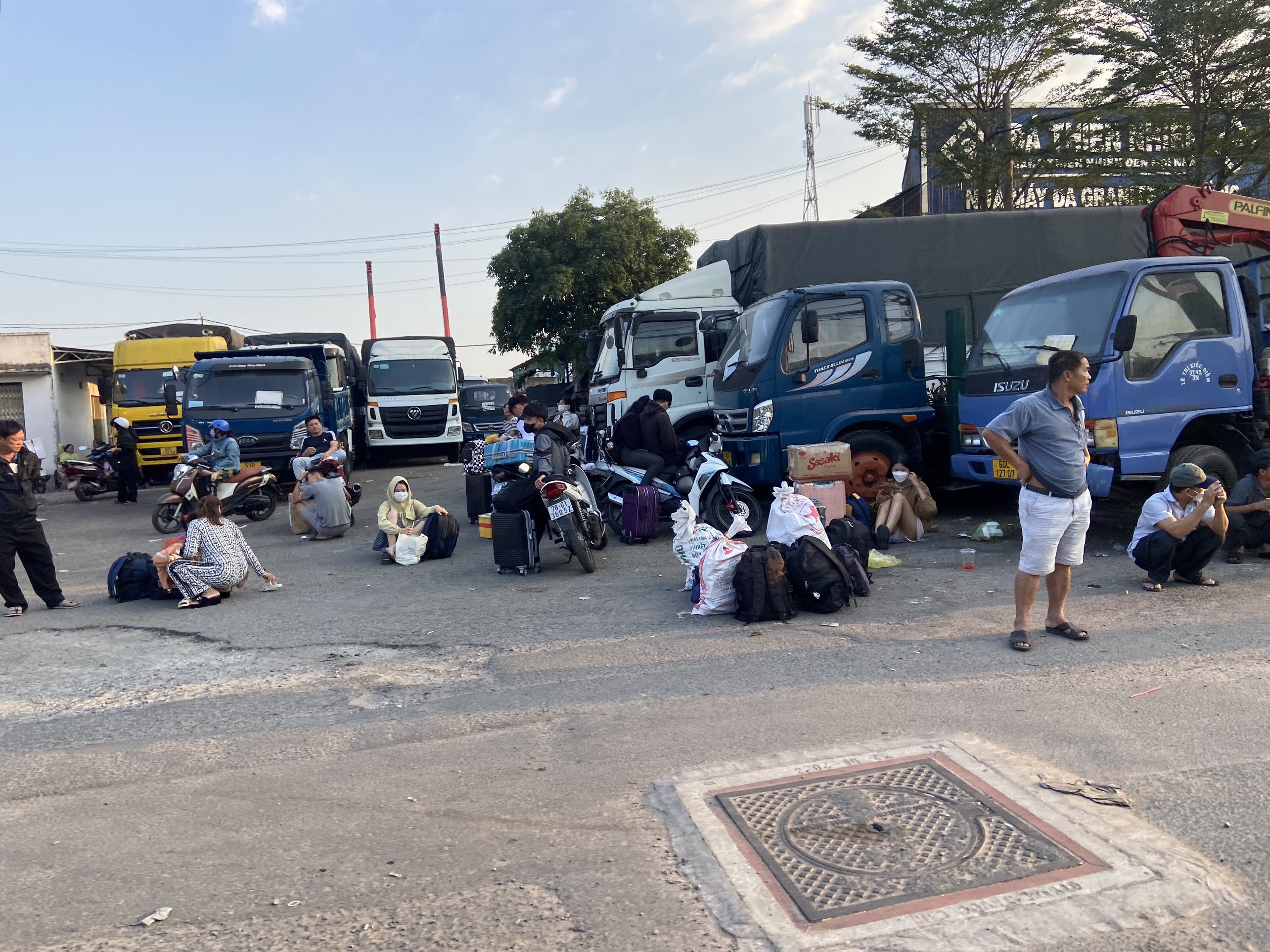 Người dân lỉnh kỉnh đồ đạc đứng dọc tuyến đường Quốc lộ 1, đoạn qua địa bàn quận 12, TP.HCM để đón xe khách về quê ăn Tết.
