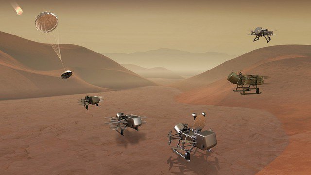 Bề mặt khu vực sa mạc của Titan trong bức ảnh đồ họa có sự hiện diện của Dragonfly, tàu vũ trụ dạng chuồn chuồn mà NASA định phóng năm 2027 với sứ mệnh đổ bộ Titan - Ảnh: NASA