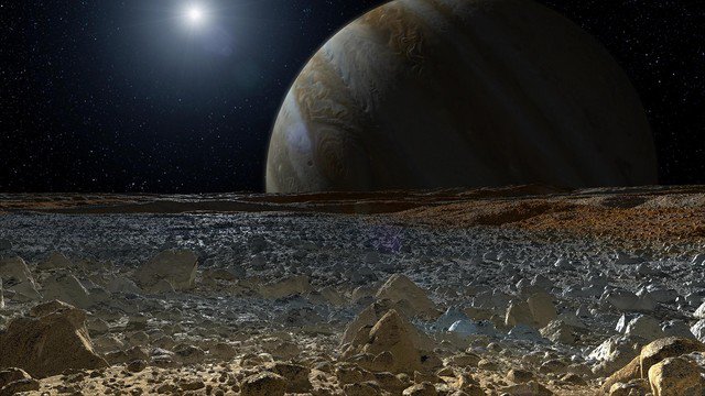 Bề mặt "mặt trăng sự sống" Europa với bóng Sao Mộc ở phía xa - Ảnh: NASA