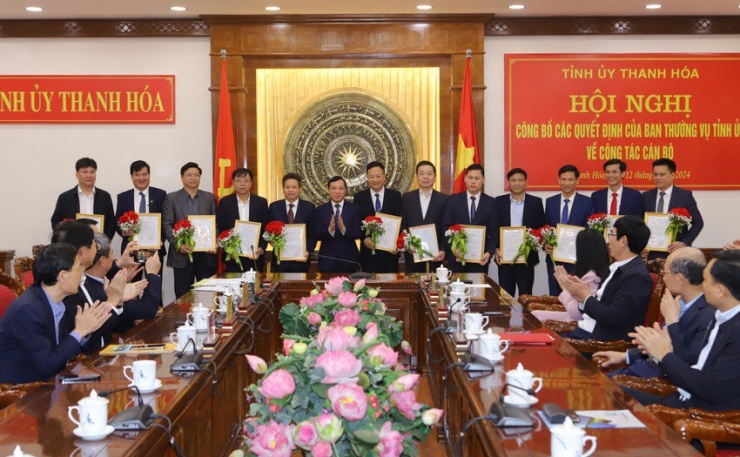 Phó Bí thư Thường trực Tỉnh ủy lại Thế Nguyên trao quyết định và tặng hoa 12 cán bộ nhận nhiệm vụ mới. Ảnh: ĐT