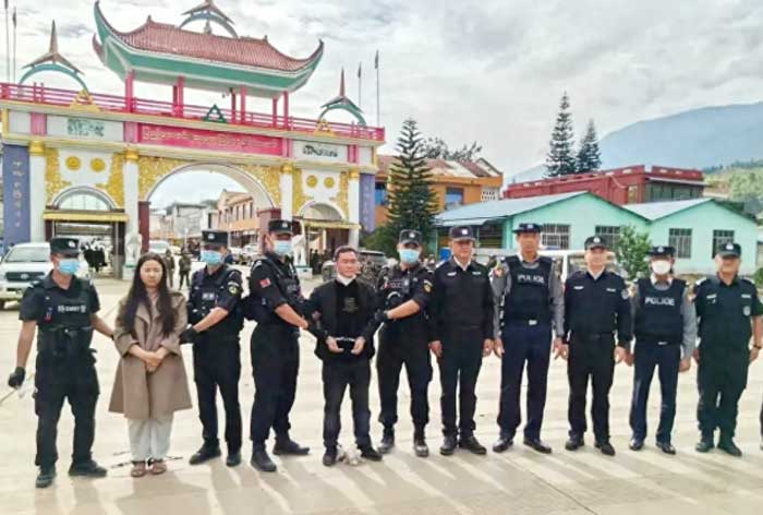 Cảnh sát Trung Quốc bắt giữ Minh Chân Chân và Minh Quốc Bình (hai người bị còng tay) tại biên giới.