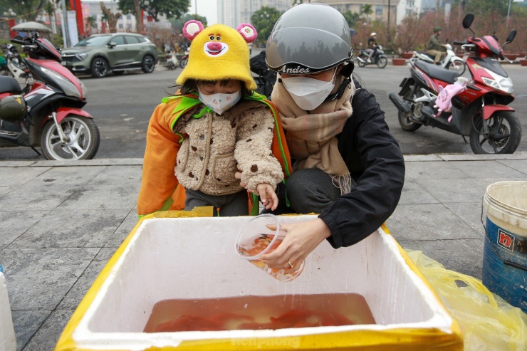 Anh Thư (6 tuổi) cùng mẹ đi thả cá. "Thư rất ham học hỏi, tôi cho cháu đi được trải nghiệm và hiểu hơn về văn hoá dân tộc Việt Nam", chị Tuyền cho hay.