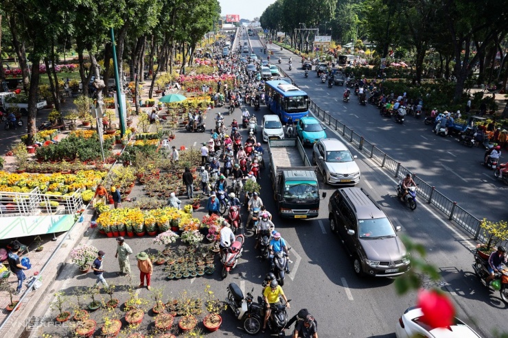 Lúc 9h, công viên Gia Định (quận Gò Vấp) trên vỉa hè và một phần đường Hoàng Minh Giám tấp nập xe cộ dừng lại hỏi mua hoa. Đây là một trong những chợ hoa lớn nhất thành phố dịp Tết. Trong ngày cuối chợ hoa mở cửa, các chủ hàng đồng loạt giảm giá, xả hàng kịp trả mặt bằng trước 12h hôm nay.