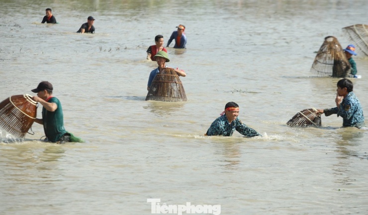 Các "nơm thủ" thi nhau nơm xuống hồ với mong muốn bắt được con cá lớn đầu tiên để nhận giải thưởng từ Ban Tổ chức. (Ảnh: Rạng Đông).