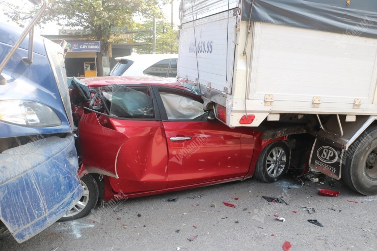 Ô tô con bị biến dạng hoàn toàn, kẹt dưới gầm xe tải. Ảnh: Quang Hưng