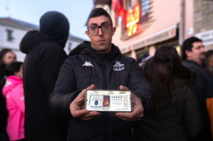 Một người dân làng Villamanín khoe tấm vé trúng độc đắc hôm 22/12/2025. Ảnh: El Pais