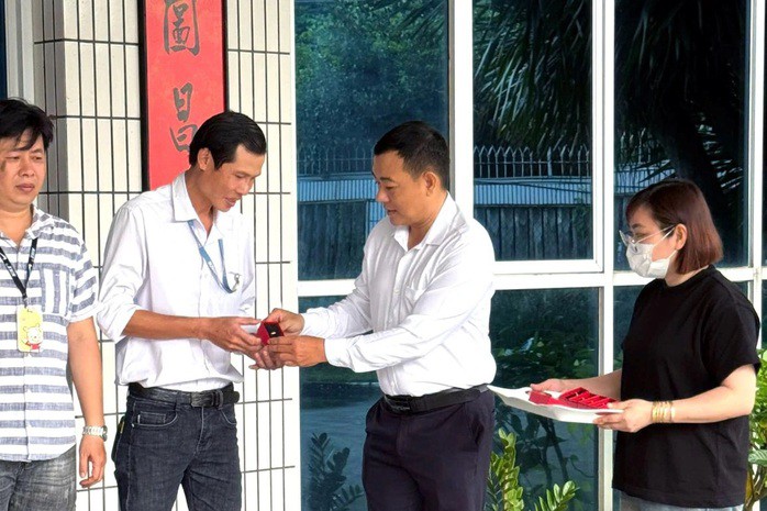 Ông Nguyễn Văn Bé Ba, Chủ tịch Công đoàn cơ sở Công ty TNHH Dụ Đức Việt Nam, tặng quà cho công nhân có thâm niên đủ 15 năm làm việc tại công ty. Việc tặng quà diễn ra vào tháng 11-2025. Ảnh: Công đoàn cơ sở Công ty TNHH Dụ Đức Việt Nam