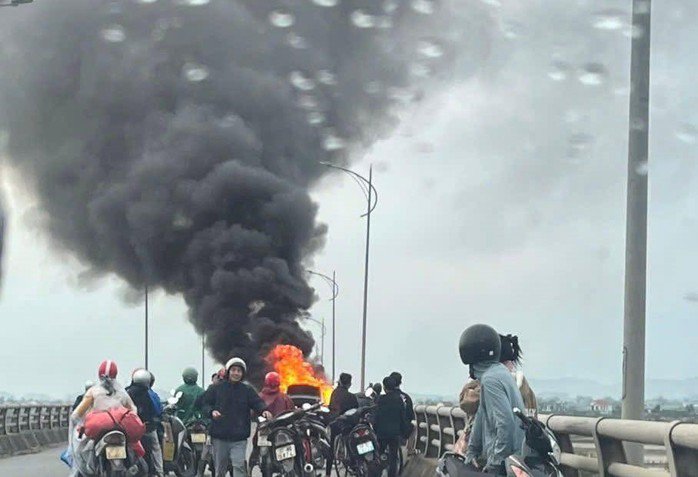 Nhiều người dân bất chấp nguy hiểm đứng xem xe ô tô bốc cháy trên cầu Yên Xuân. Nguồn: MXH