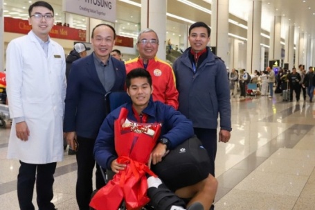 Hậu vệ U23 Việt Nam ngồi xe lăn xuống máy bay, bác sĩ đưa thẳng đến bệnh viện