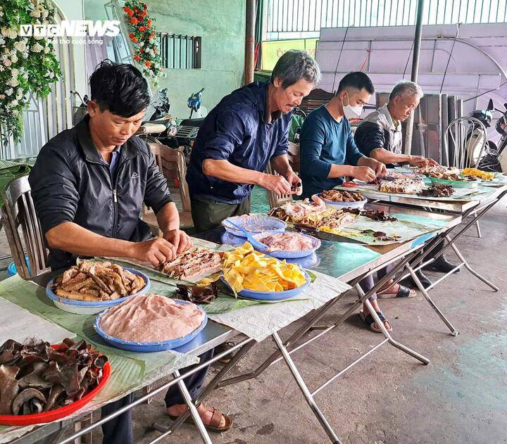 Việc gói giò chả Vũ Đông được thực hiện thủ công bằng tay, đòi hỏi kỹ năng sắp xếp để cho ra miếng giò bắt mắt. (Ảnh: Khánh Linh)