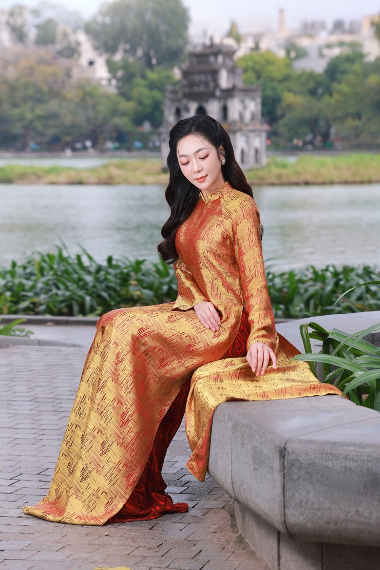 Cô tạo dáng với khung cảnh Tháp Rùa cổ kính phía xa xa, lưu giữ kỷ niệm chuyến thăm Hà Nội.