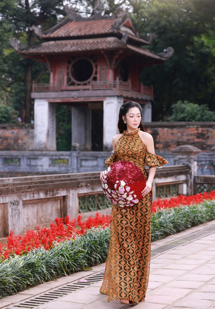 Cô diện áo dài cách điệu cổ yếm kết hợp phụ kiện nón lá họa tiết ấn tượng, sải bước trong khu di tích nổi tiếng - một trong những biểu tượng của thủ đô.
