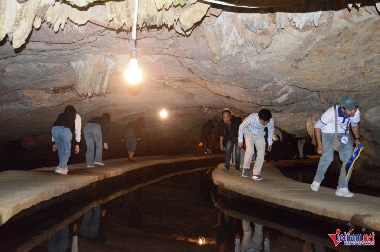 Du khách tham quan động Tiên Cá sẽ đi bộ trên cây cầu nổi uốn lượn trong lòng núi đá&nbsp;