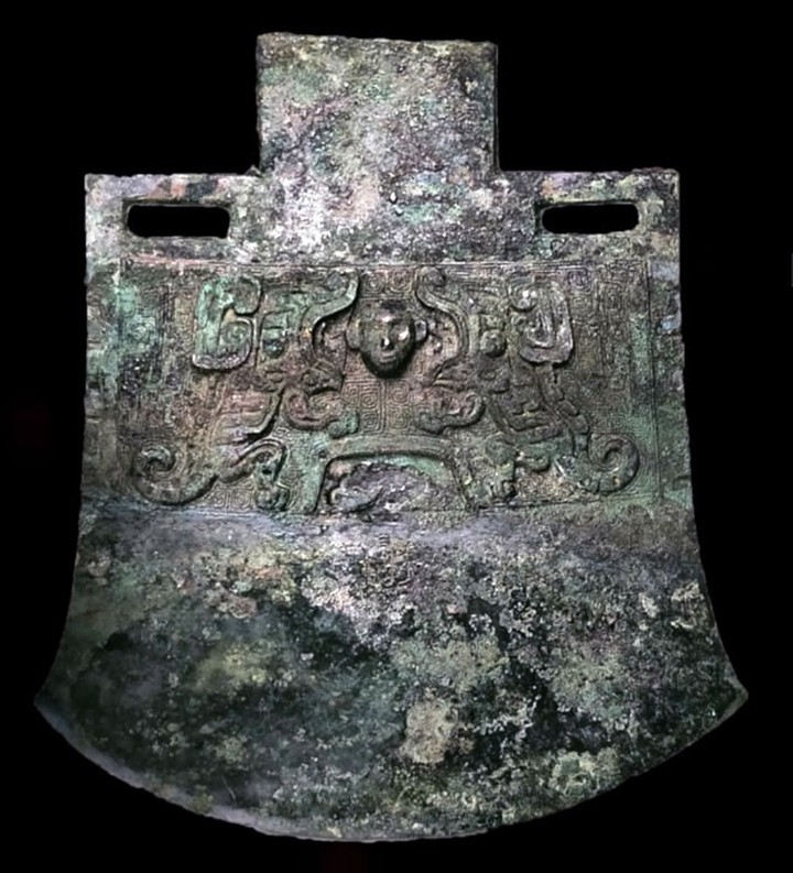 Rìu trang trí đôi rồng đang quay mặt vào nhau, miệng há to trước một đầu người. (Ảnh: Khan Academy)