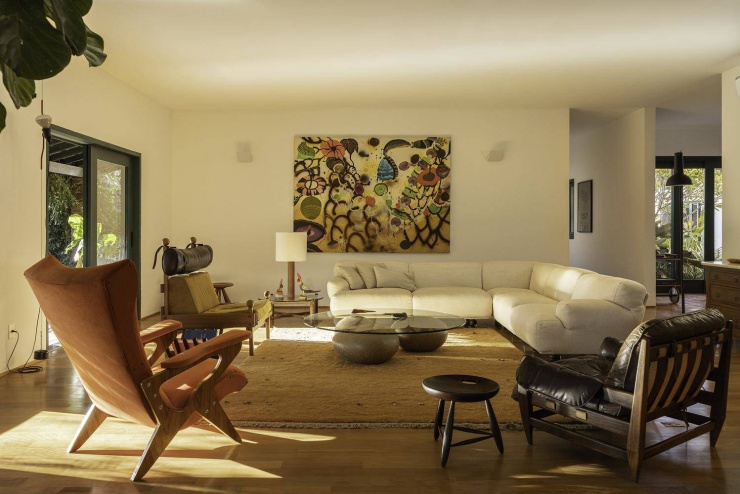 Không gian phòng khách rộng lớn với sàn gỗ thay thế cho nền đá cũ. Nguồn: Archdaily