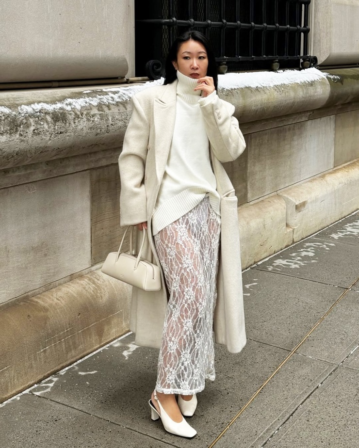 Với áo len cao cổ, để tạo nên vẻ ngoài bắt mắt hơn trong dịp Tết, bạn hãy phối chân váy midi xuyên thấu hoặc ren, sequin. Hãy kết hợp thêm áo khoác dáng dài để giữ ấm và tạo nên vẻ ngoài quyền lực.