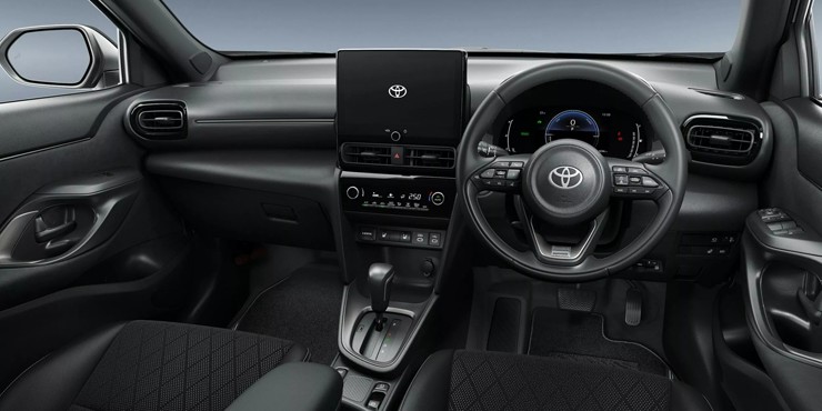 Nội thất trên Toyota Yaris (trái) và Yaris Cross 2026 (phải) có thiết kế tương đồng với bảng điều khiển trung tâm tối giản và hệ thống màn hình giải trí đặt nổi.