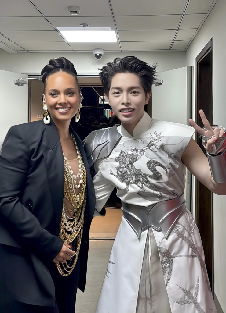 Đức Phúc mặc trang phục tôn vinh văn hóa Việt chụp ảnh cùng ngôi sao Alicia Keys tại hậu trường sự kiện hồi tháng 12/2025 ở Hà Nội.