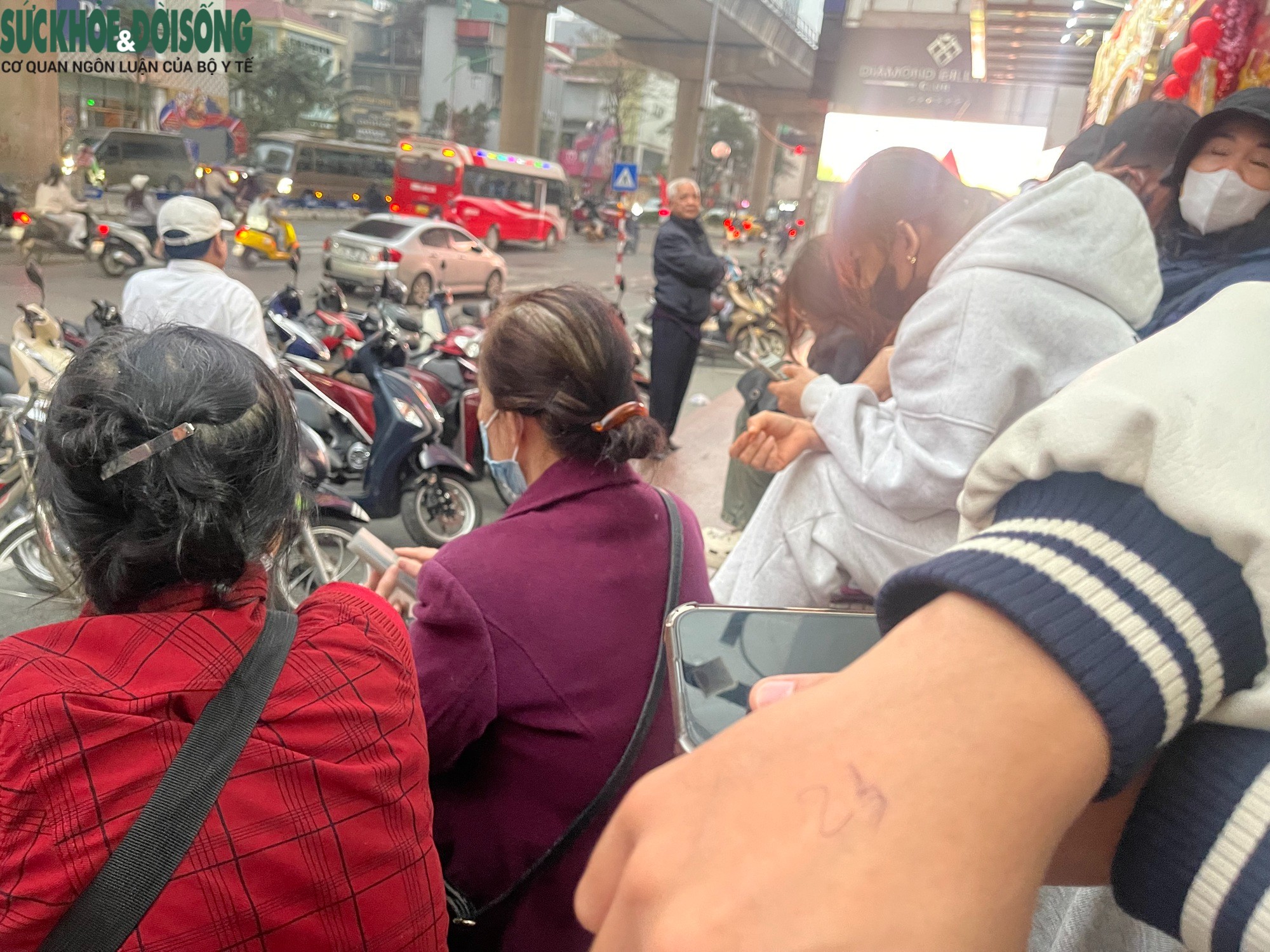 Việt trò chuyện cùng bạn trong lúc chờ đợi cửa hàng mở cửa, mua vàng.