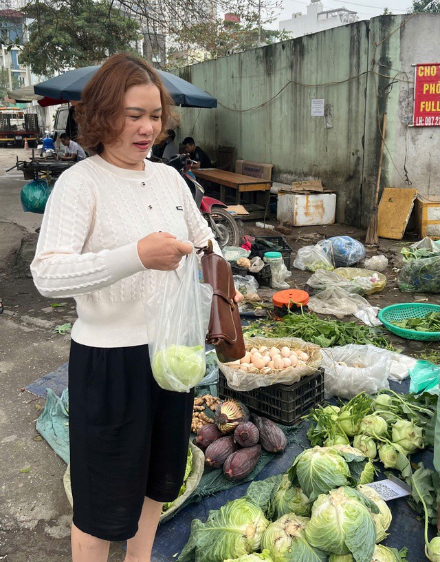 Chị Yến chọn mua rau xanh để “giải ngấy” sau những ngày ăn nhiều đạm. Ảnh: Đan Tâm.