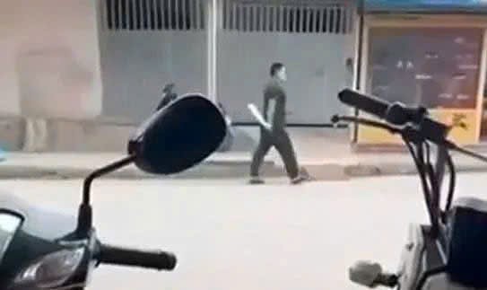 Sau khi chém nạn nhân trọng thương đối tượng cầm dao đi lại trên đường. Ảnh: T. Vinh