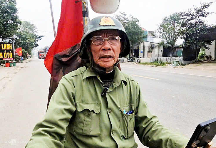 Ông Phạm Ngọc Chiêng chạy chiếc xe máy gắn loa phát thanh tuyên truyền bầu cử. Ảnh:&nbsp;Lam Sơn