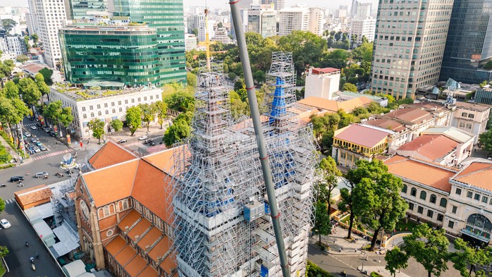 9 giờ sáng 19-3, hai thánh giá mới chính thức được đưa lên và cố định trên đỉnh chóp nhọn của Nhà thờ Đức Bà TPHCM