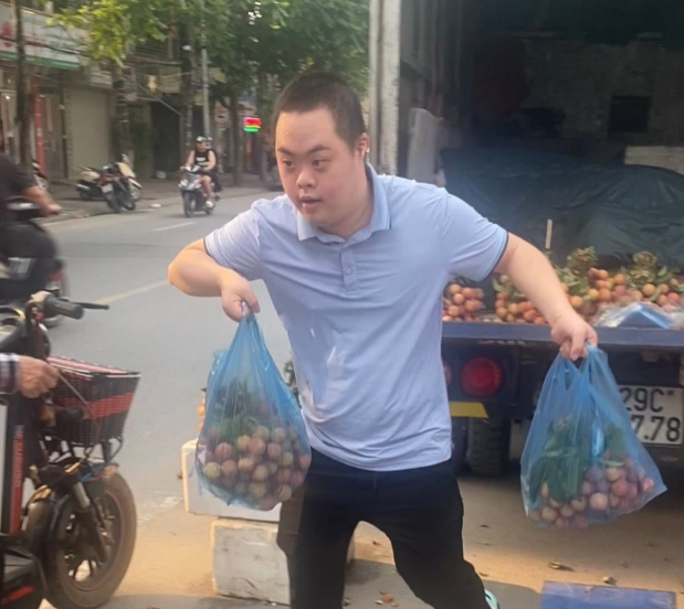 Bảo Sơn phụ giúp bố mẹ bán hoa quả trên đường. Ảnh: NVCC