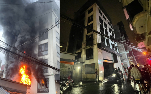 Lực lượng chức năng hướng dẫn 7 người thoát nạn qua tầng tum sang nhà bên cạnh trong vụ cháy nhà dân tại Lĩnh Nam, Hoàng Mai, Hà Nội.