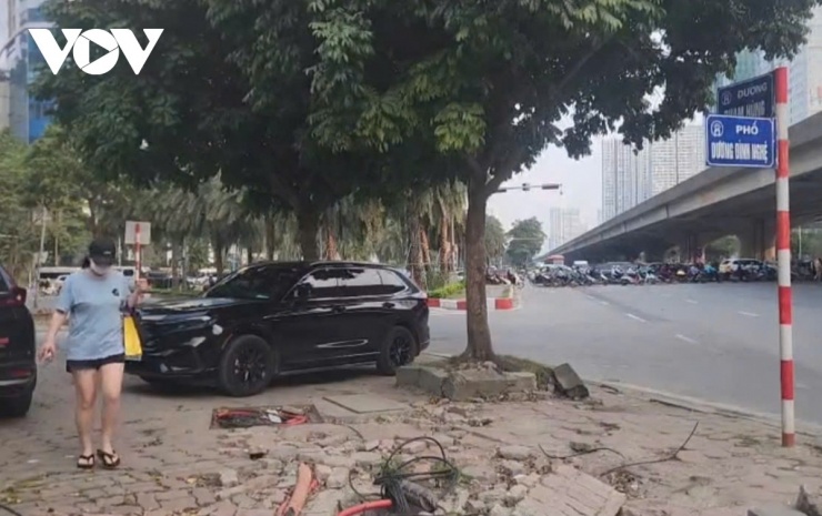 Người đi bộ trên vỉa hè bong tróc không đảm bảo an toàn.