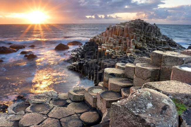 Giant's Causeway, Bắc Ireland: Vùng bờ biển thuộc hạt Altrim, Bắc Ireland, Vương quốc Anh. Bờ biển này thu hút rất đông khách du lịch và các nhà nghiên cứu đến đây bởi tại đây có khoảng 40.000 cột bazan khổng lồ màu đen được xếp ngay ngắn, kết quả của một vụ phun trào núi lửa cổ xưa cách đây 50-60 triệu năm.