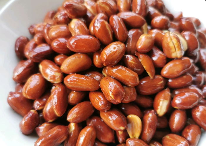 Khi lạc vẫn còn đang nóng, đổ một chút rượu nấu ăn vào, đảo đều. Rượu nấu ăn sẽ làm cho độ ẩm trong lạc còn sót lại bay hơi hoàn toàn, do đó lạc sẽ giòn hơn rất nhiều. Cuối cùng là rắc thêm một chút muối lên trên và thưởng thức.