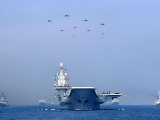Tàu hải quân, máy bay chiến đấu Trung Quốc trong một lần xuất hiện ở Biển Đông. Ảnh: REUTERS