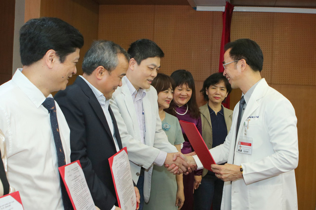 Ông Nguyễn Quang Tuấn, Giám đốc Bệnh viện Bạch Mai, chúc mừng các bác sĩ được nhận quyết định Bác sĩ cao cấp cách đây ít ngày - Ảnh: Bệnh viện Bạch Mai