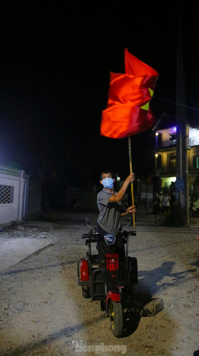 Dù phải đi lại bằng xe lăn điện nhưng bác vẫn ra chung vui và cố gắng phất cao ngọn cờ của đất nước.