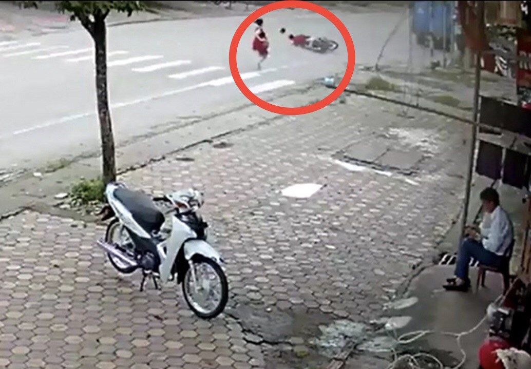 Sau va chạm với người phụ nữ đi bộ dưới phần đường xe chạy, người đi xe máy ngã nhào xuống đường.
