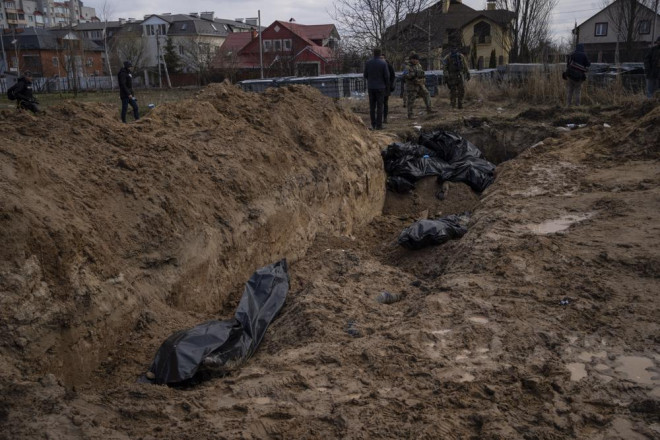 Hố chôn tập thể ở Bucha được cho liên quan đến hành động thảm sát của Nga. Ảnh: AP