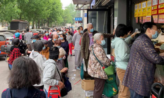 Người dân Bắc Kinh xếp hàng mua thực phẩm hôm 25-4 sau khi giới chức thành phố này thông báo thêm 19 ca nhiễm. Ảnh: Reuters